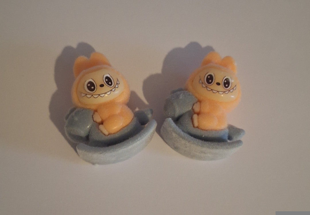 Orange labubu on grey rocking horse felt feel beads