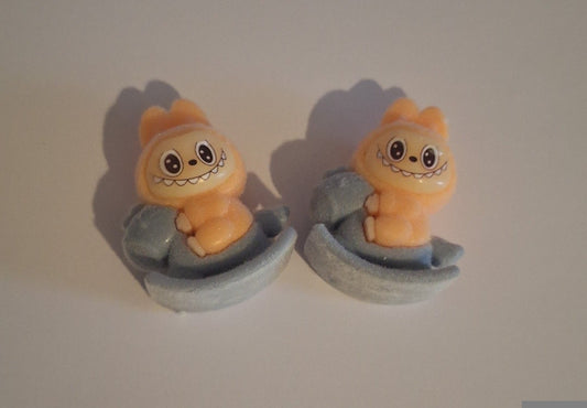 Orange labubu on grey rocking horse  felt feel beads